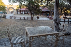 Outdoor table overlooking ranch festivities.
